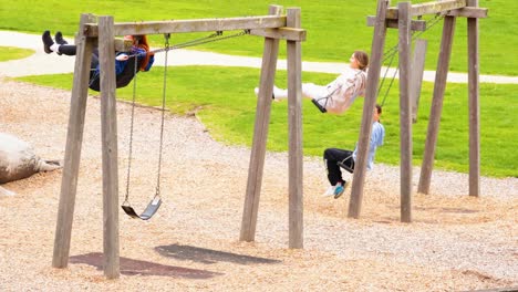 kids enjoying swings on a sunny day