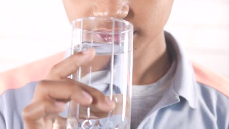 teenage boy drinking glass of water ,