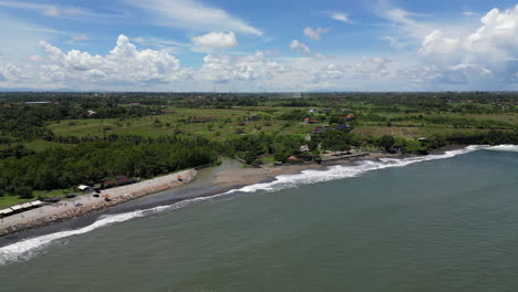 balinese farm land stretches down to the ocean near tanah lot indonesia