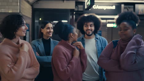 diverse group of people waiting at a subway station