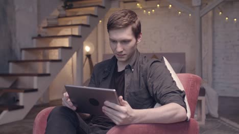 Man using tablet in a living room