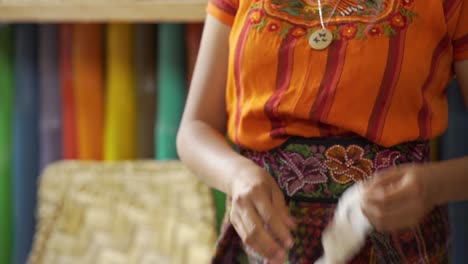 Beautiful-close-up-of-a-Maya-woman-weaver-separates-the-seeds-from-cotton-fibers-by-hand