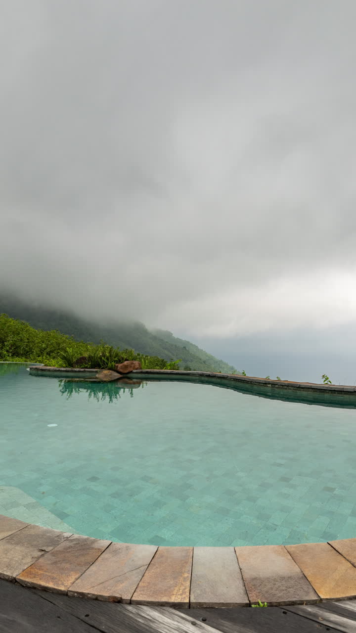 luxury swimming pool set in lush scenery of palm trees