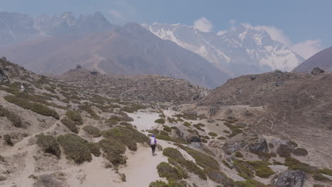 top-down drone view of tourists hiking across dry landscapes at dingboche enroute everest base camp. scenic mountains and adventure trails in nepal, hills, mountains, horizon, travel tourism
