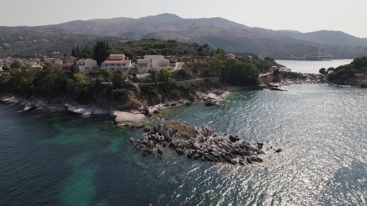 Aerial flyover of hidden beaches and reefs on the island Corfu, quiet tourist place Kassiopi