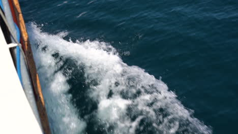 view from side of moving sailing boat on blue sea in bali indonesia