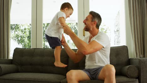padre e hijo divirtiéndose en el sofá 4k