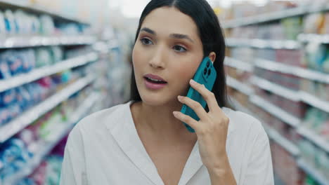 woman talking on phone in grocery store