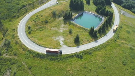 Luftdrohnenansicht-Der-Belebten-Bergstraße-Mit-Großen-Lastwagen-Auf-Der-Straßenkurve