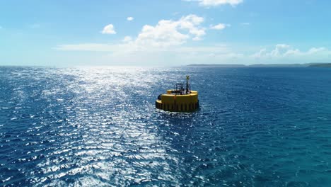 Yellow-mooring-buoy-in-deep-blue-Caribbean-ocean,-small-wind-wave-ripples,-aerial-orbit