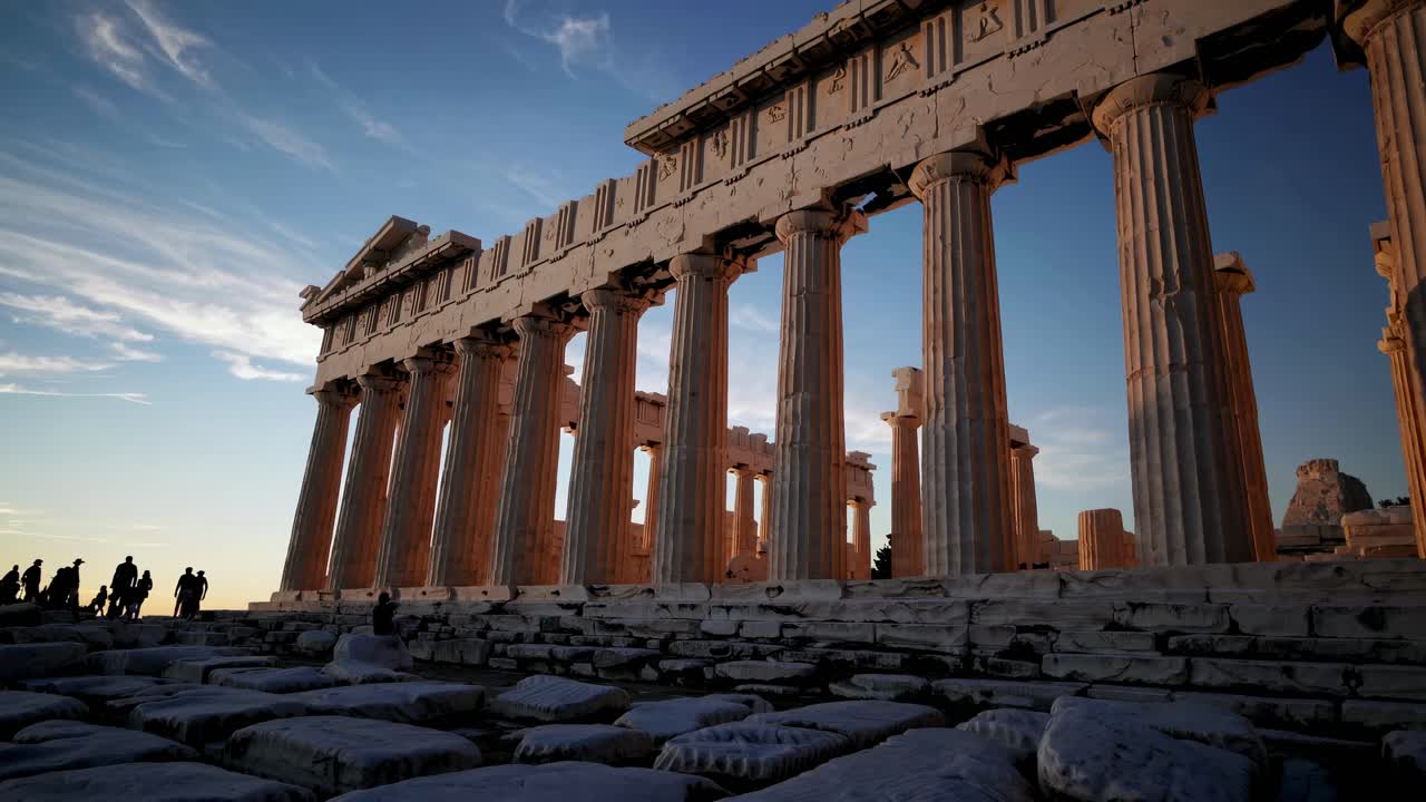 A low-angle video captures the Parthenon's majestic columns at sunset, highlighting ancient