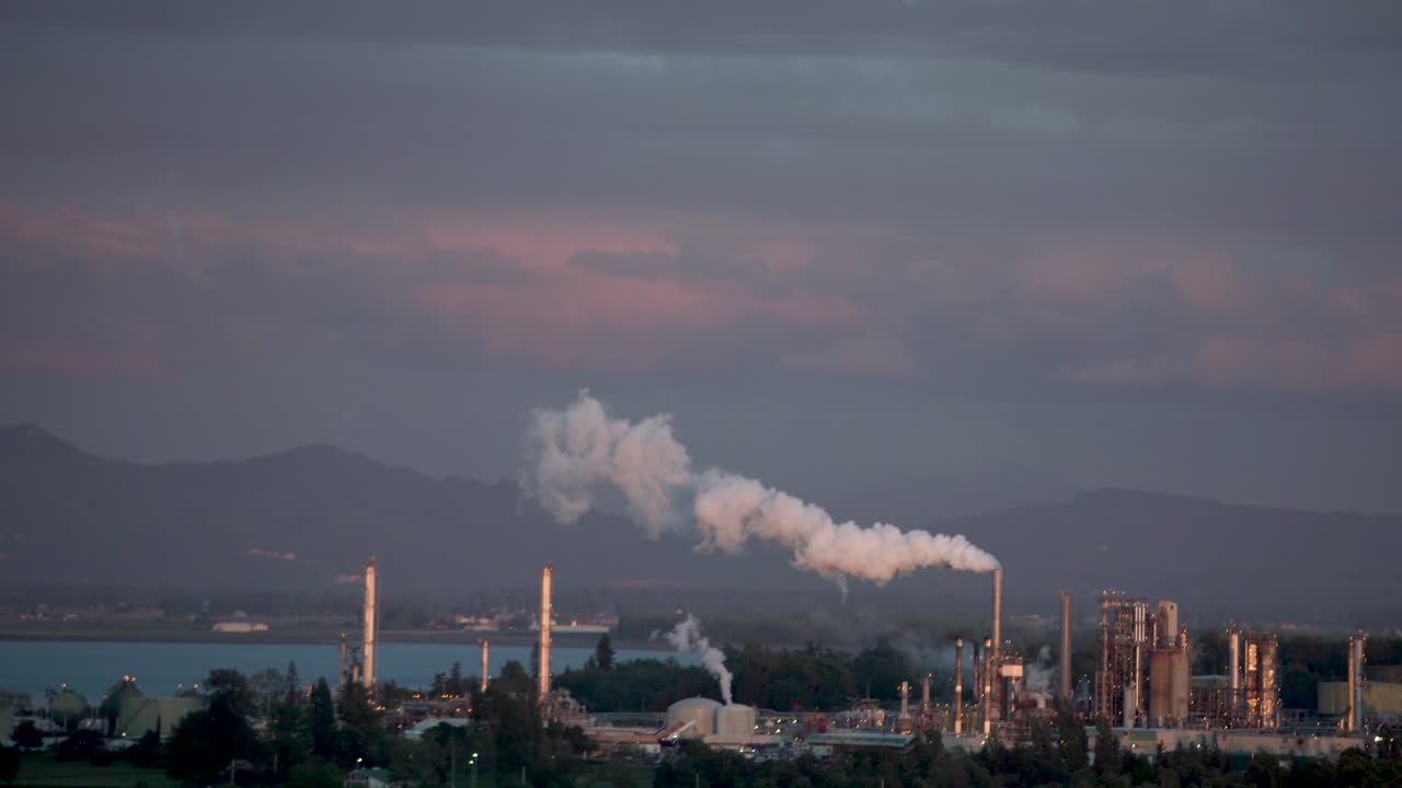 Smoke Rising Up From The Oil Refinery Chimneys In Cap Sante, Anacortes, USA. - wide shot