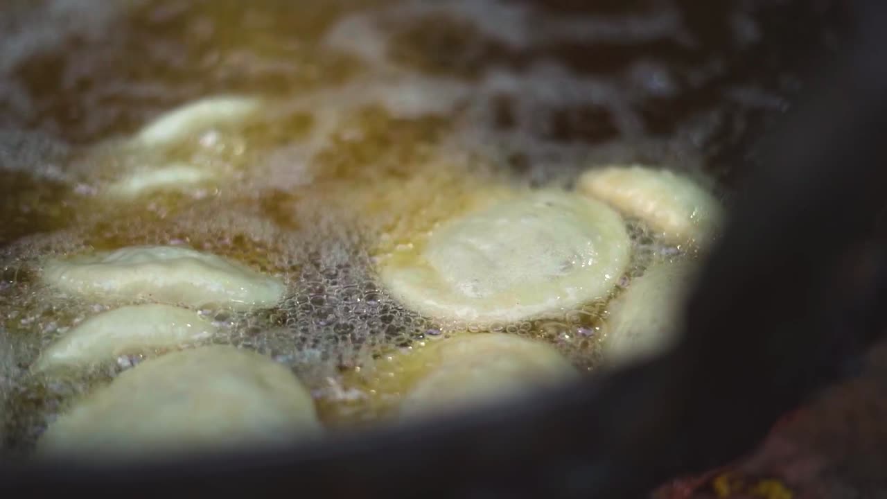 Slow motion shot of oil frying of kachori street breakfast in gwalior india