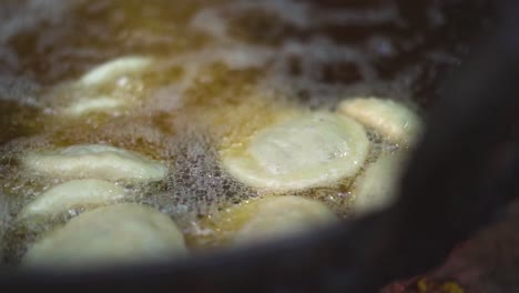 slow motion shot of oil frying of kachori street breakfast in gwalior india