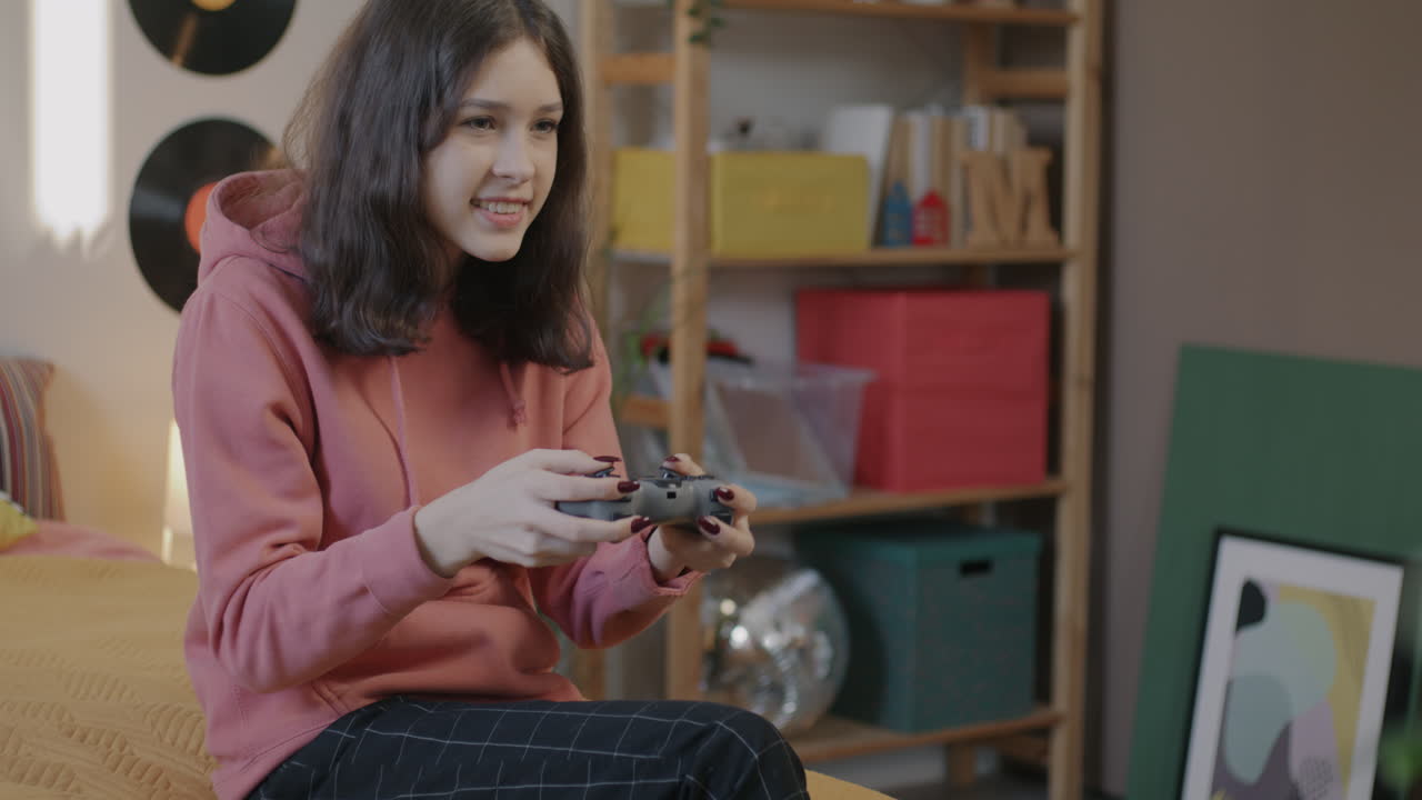 Teenage Girl Playing Video Games in Her Bedroom
