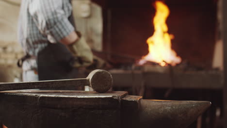 hammer on anvil in blacksmith workshop