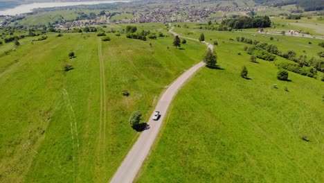 drive through pasture and meadow on summer voyage, countryside getaway, aerial