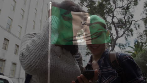 smiling at phone, two people with nigerian flag overlay in urban setting