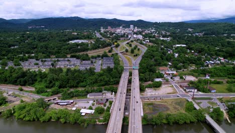 asheville north carolina, asheville nc, aerial approach to city with highway below