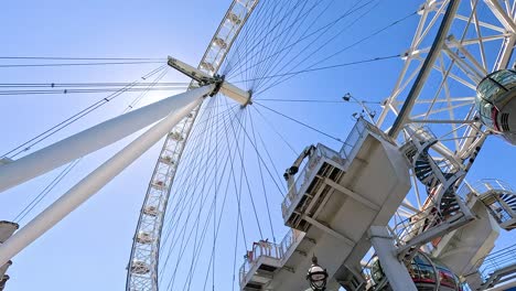 ferris wheel rotating against a clear blue sky