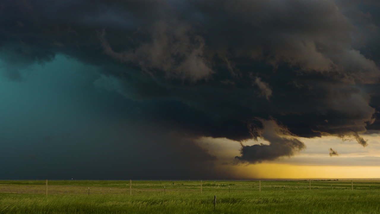 Time lapse of storm clouds full of color moving across beautiful open plains