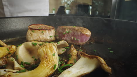 cooking steak with mushrooms in a pan