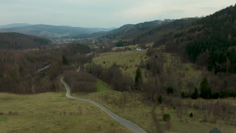 aerial view of a valley with a winding road and scattered houses