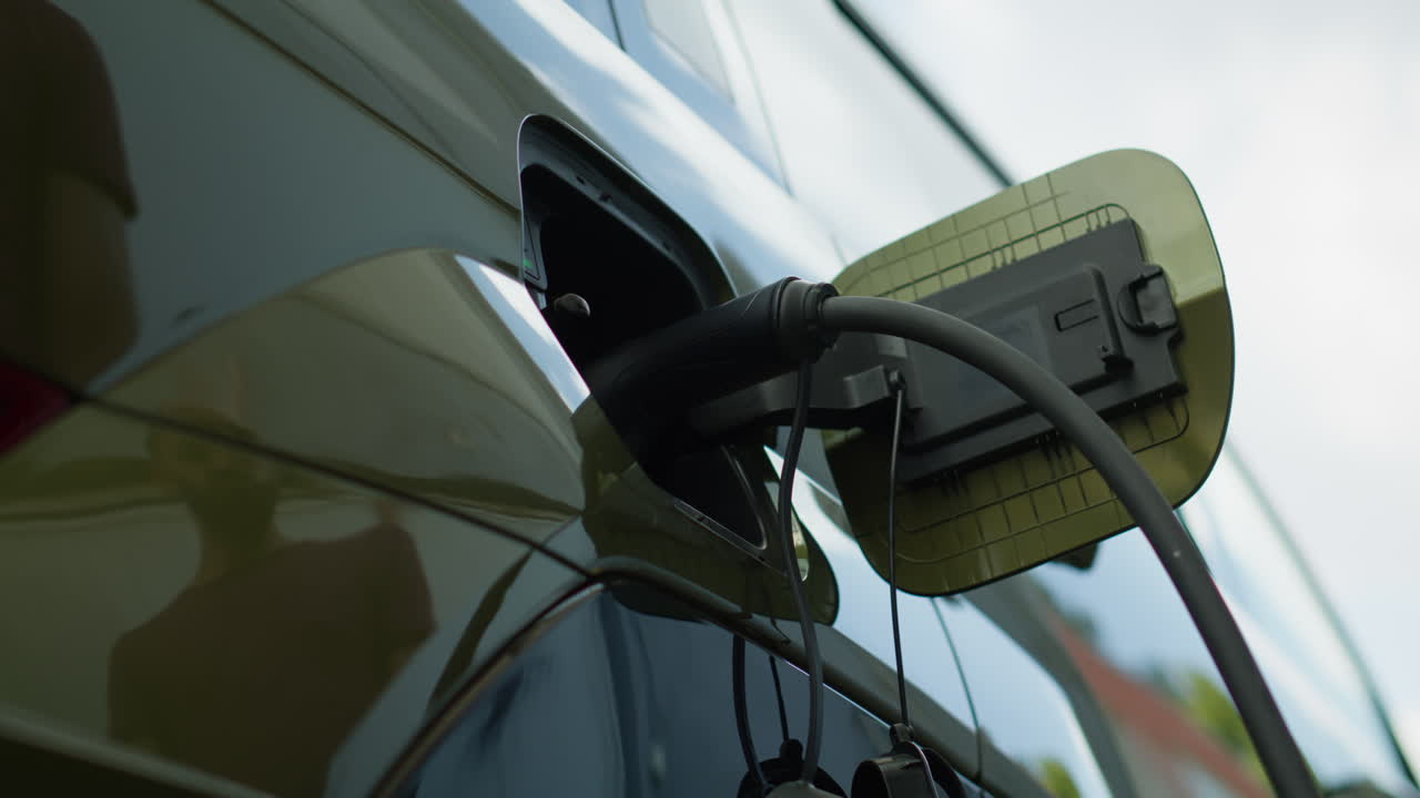 Close Up Of Driver Recharging Ev Vehicle Battery, Low Angle Shot