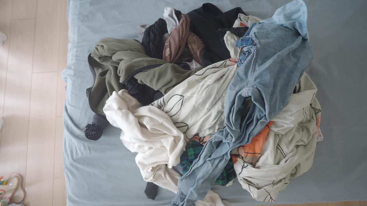 Pile of Clothes on a Bed