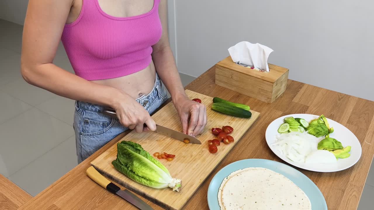 mulher preparando um invólucro de vegetais saudáveis