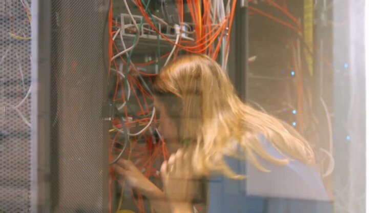 Technician looking at open server locker