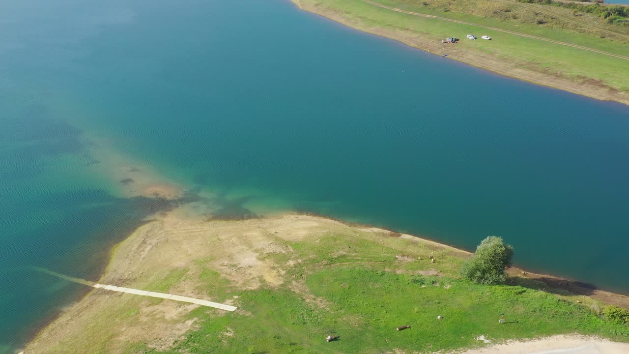 Rama Lake in Bosnia and Herzegovina with Mediteran Caffe Restaurant near the shore, Aerial flyover shot