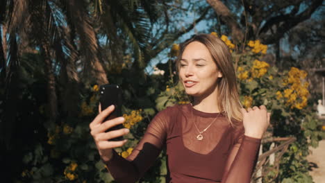 young woman talking on video chat outdoors.