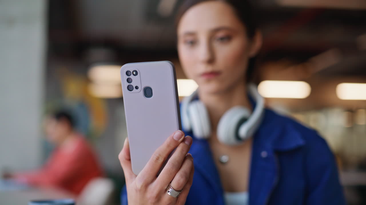 Happy freelancer looking smartphone notification in coworking office closeup