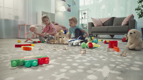 brother helps sister decorate roof of handmade toy house