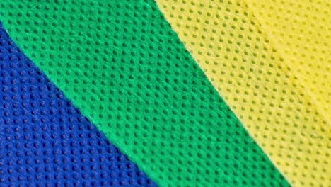 varias piezas de tela textil de diferentes colores, vista de primer plano macro con movimiento de rotación