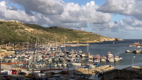 docked boats, historic mgarr harbour, gozo island malta, warm afternoon light