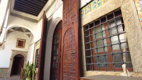 carved wooden door of the palace of the prensses dar aziza with a window