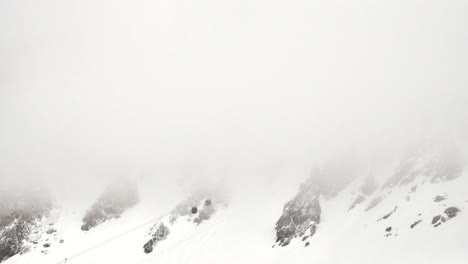 Lapso-De-Tiempo-De-Una-Burbuja-De-Telesilla-En-La-Ladera-De-Una-Montaña-Que-Se-Dirige-Hacia-Una-Nube-Baja-En-Los-Alpes-Franceses-En-Invierno