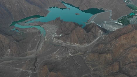 aerial view of a lake surrounded by endless mountains