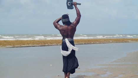 the tropical beach highlights a muscular, dark-skinned man perfectly in character for nekharis cosplay