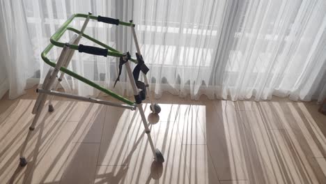 folding walker in a room with sunlight and shadows