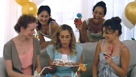 woman blowing out birthday candles