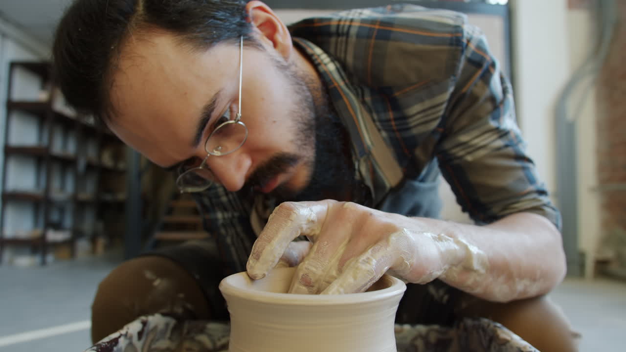 Pottery Artist Shaping Clay on a Wheel