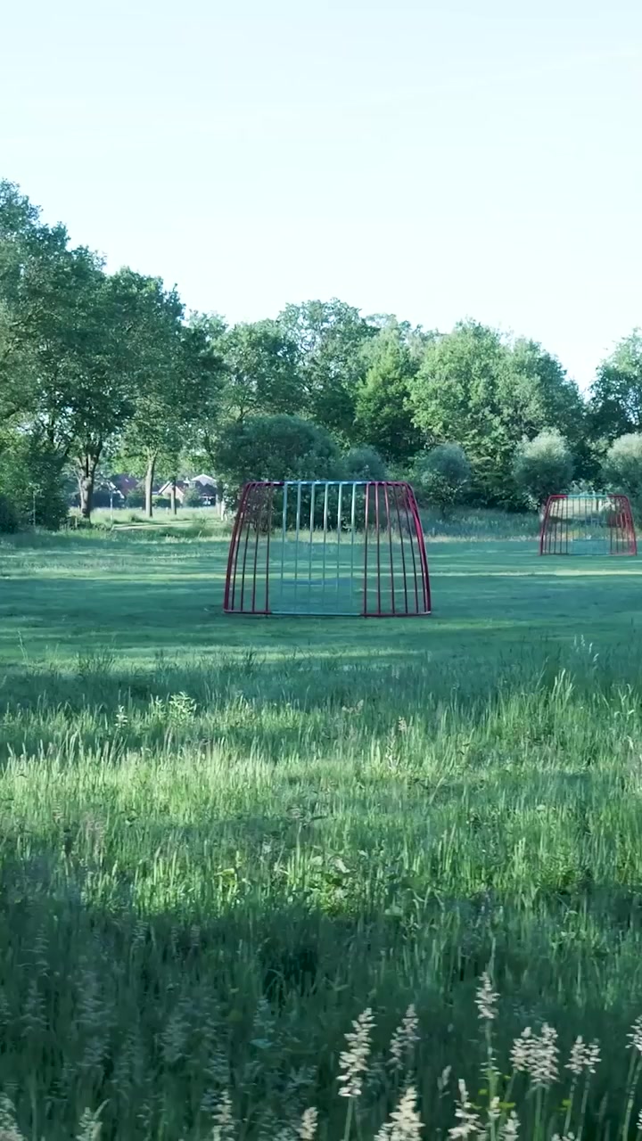 Red Soccer Goal on a Grassy Field in a Park