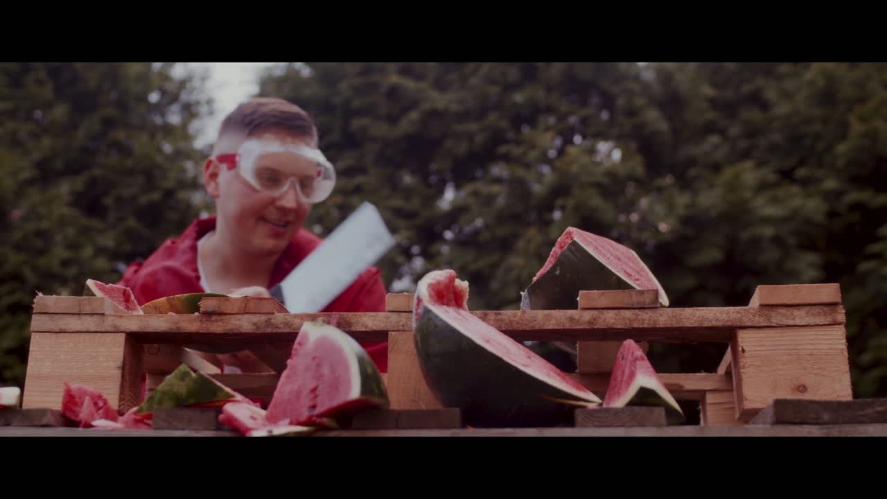 Man Smashing Watermelon with Safety Glasses