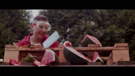 man smashing watermelon with safety glasses