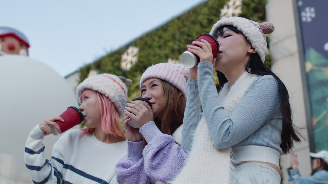 Group of women celebrating Christmas with coffee cups