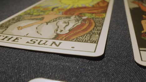 close up shot of tarot cards laid out for reading on table with candles 1