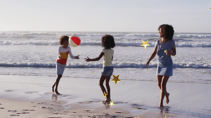 Family playing with beach ball on shore with star animation overlay
